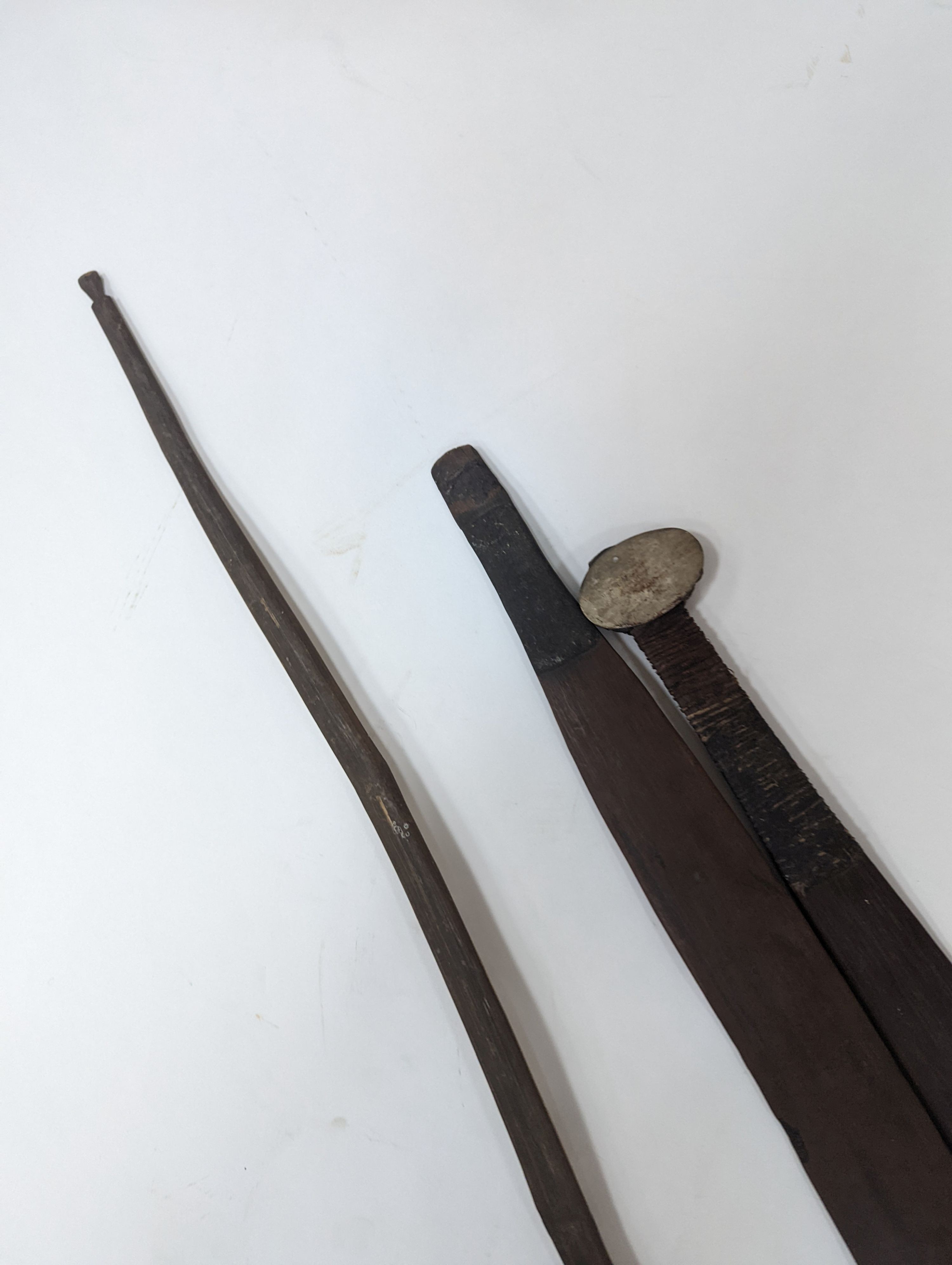 Two chip-carved paddle blades and bow, possibly Fijian.